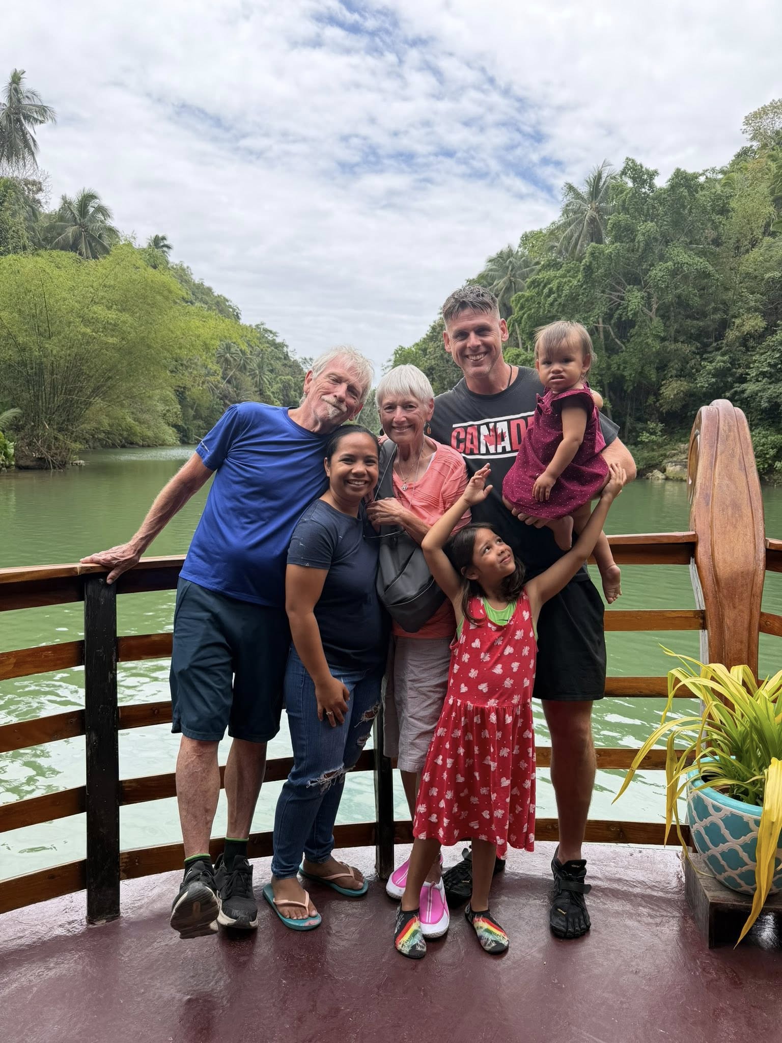 Multi-generational family on the Loboc River cruise, Bohol — grandparents, parents, and young children together on a private boat journey