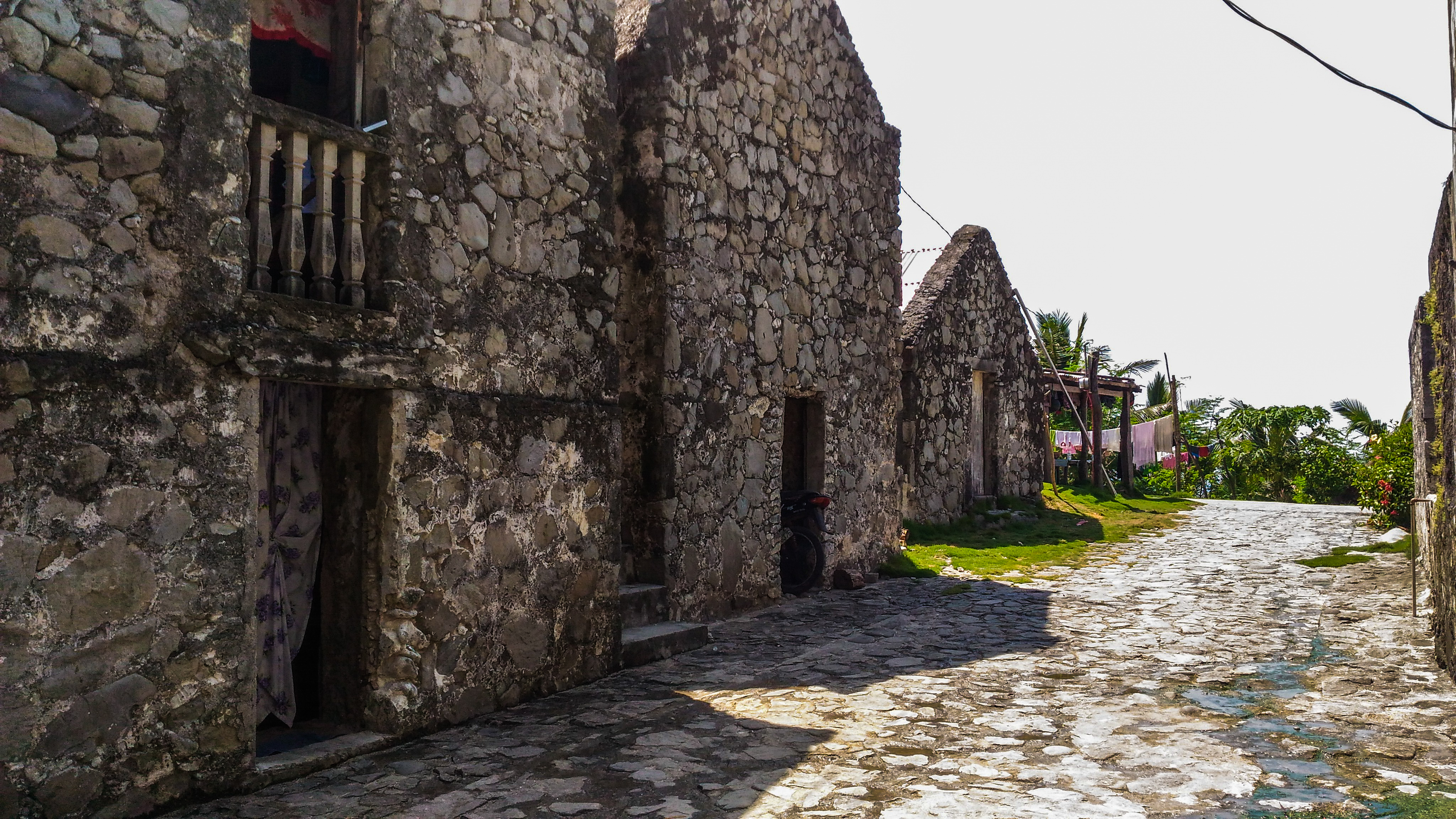 Cobblestone street lined with centuries-old Ivatan stone houses in Chavayan Village, Sabtang