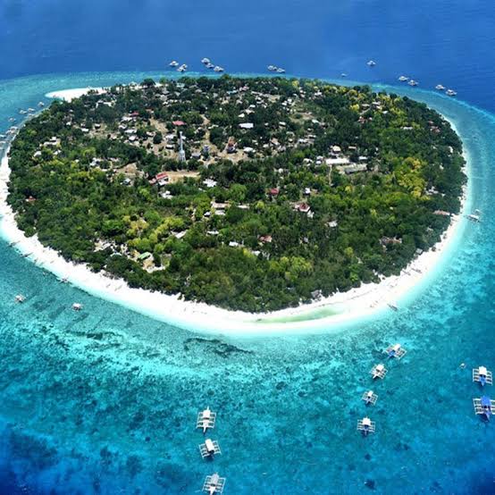Aerial view of Balicasag Island, Bohol Sea — white sand ring and turquoise reef