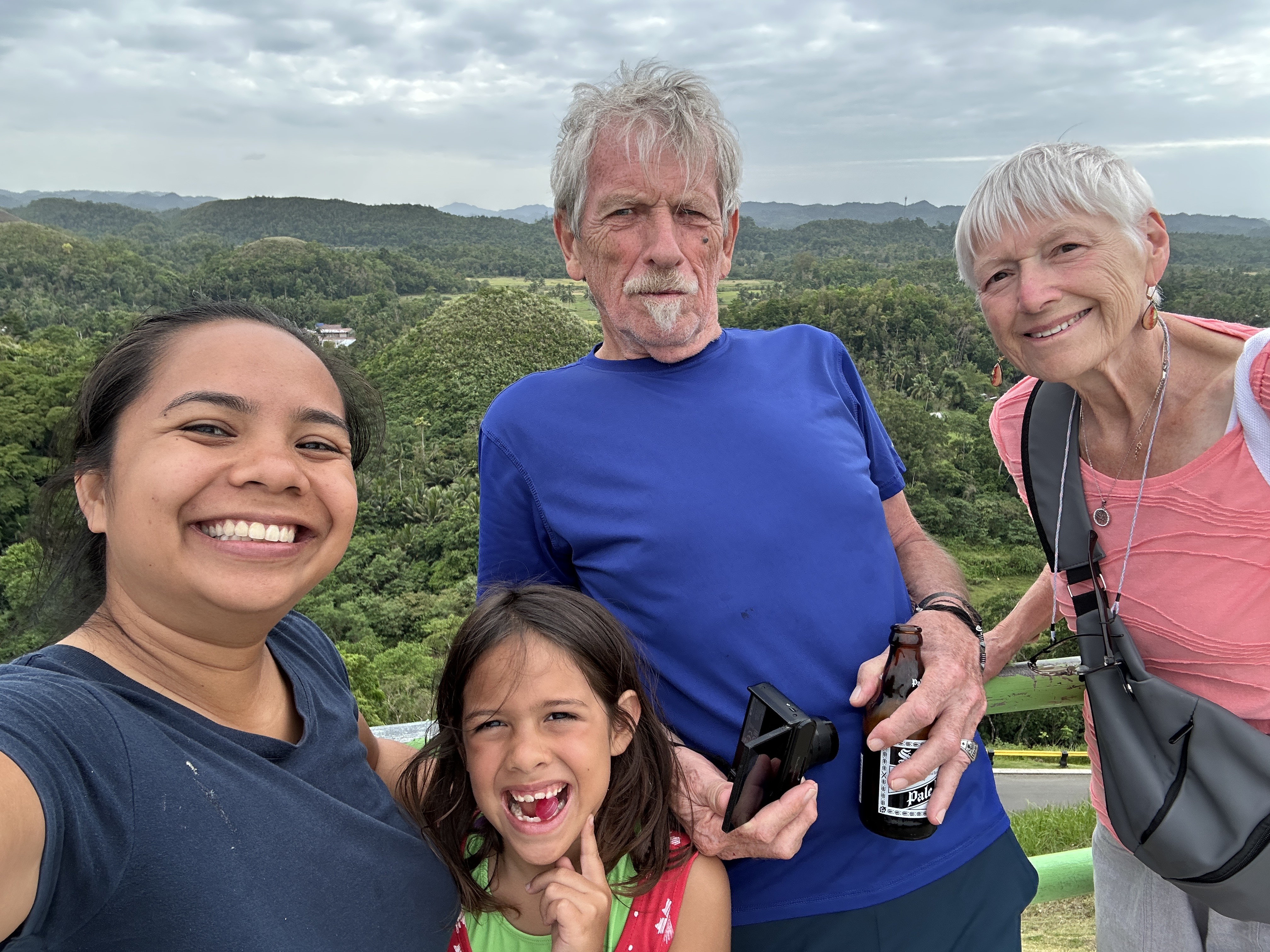 Family at the Chocolate Hills viewing deck, Carmen, Bohol — conical green mounds stretching to the horizon